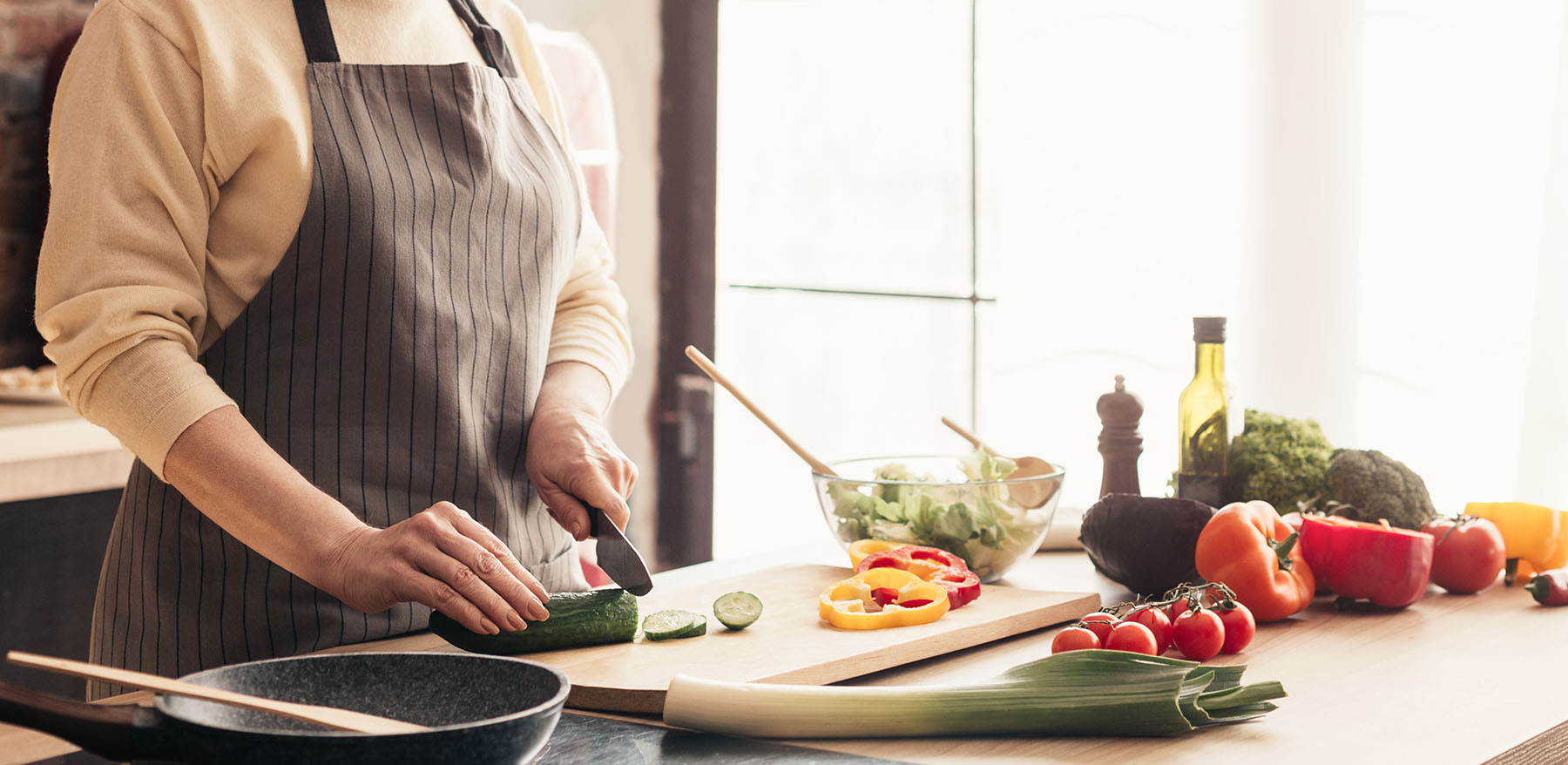 A caregiver preparing a fresh meal in a client's home kitchen
